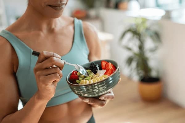 Athletic woman eating healthy